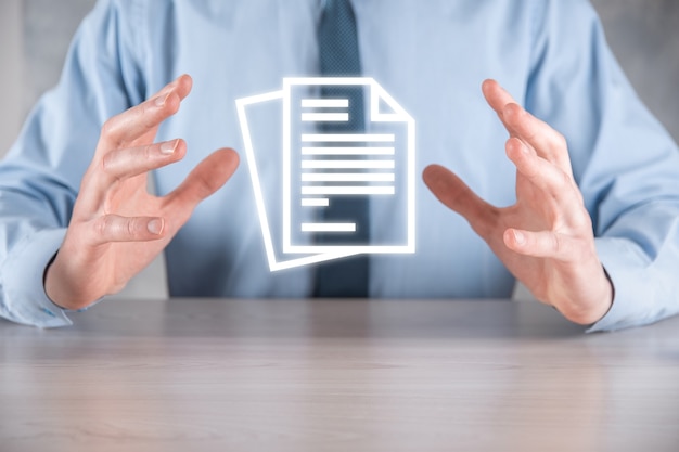 Hand holding a document icon in his hand Document Management Data System Business Internet Technology Concept. Corporate data management system DMS.