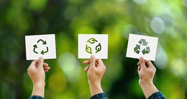 Hand holding recycle symbol 3 different icons on green bokeh background eco concept and save the world environment