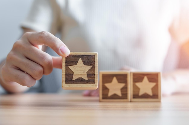 hand holding star block customer choose rating for user reviews quality service rating ranking customer review satisfaction evaluation and feedback concept