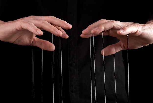 Hand manipulating and controlling smth with strings concept