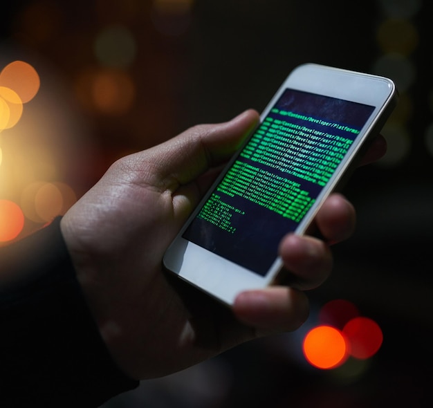 Hand smartphone and cyber security with ux screen and code for future technology and system update Person digital and communication on mobile for connection algorithm and hacking in database