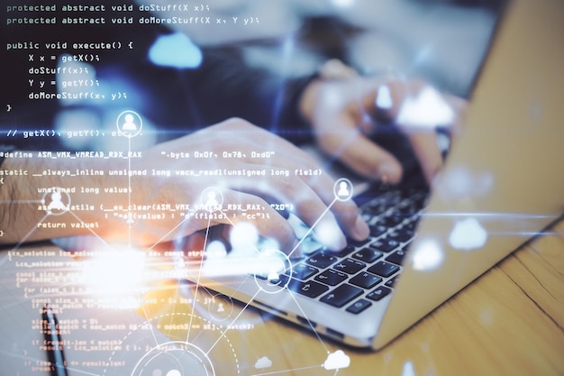 Hand using laptop on desktop with human resources hologram