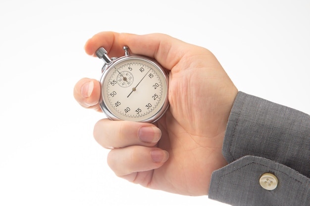 Hand with a mechanical analog stopwatch on a white background Time part precision Measurement of the speed interval