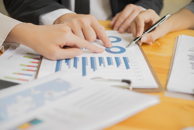 Hands pointing at chart