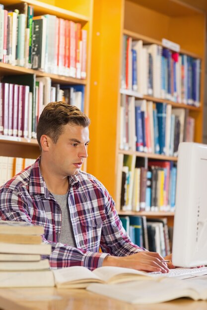 Handsome concentrating student using computer