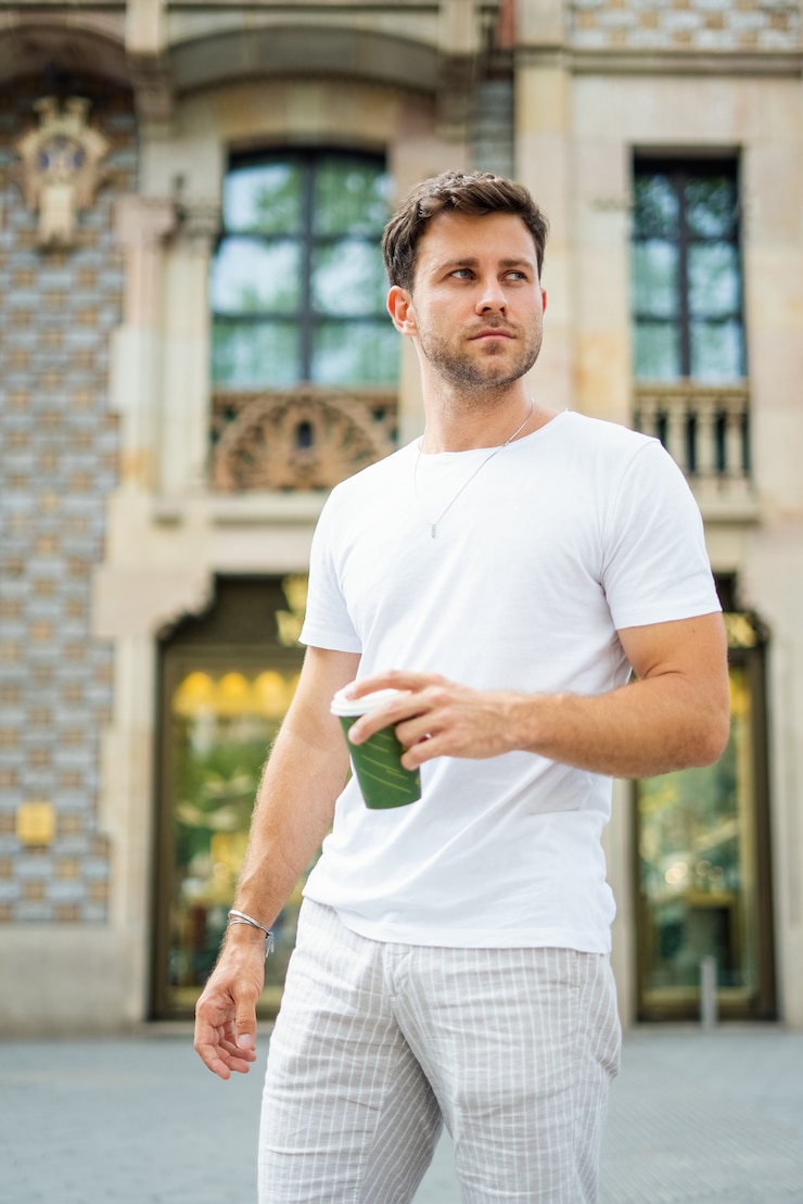 Kuva handsome man with takeaway coffee on street