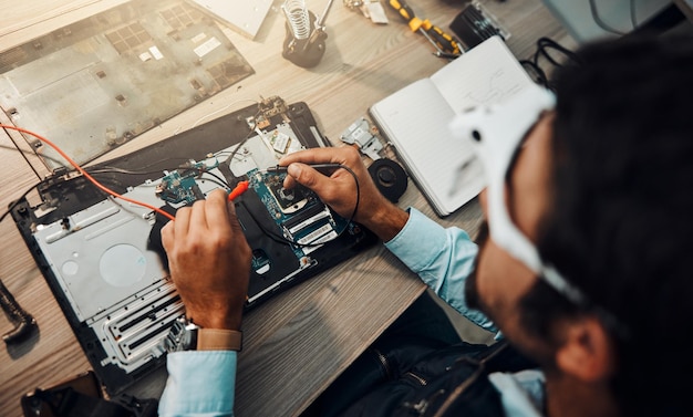 hardware engineering and it professional repair motherboard microcircuit or electronic device in a workshop or shop overhead man and guy fixing a computer for technology in a lab or factory