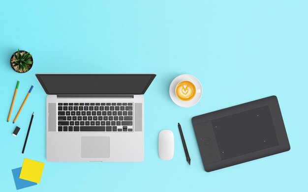 High angle view of various technology with coffee and office supplies on blue background