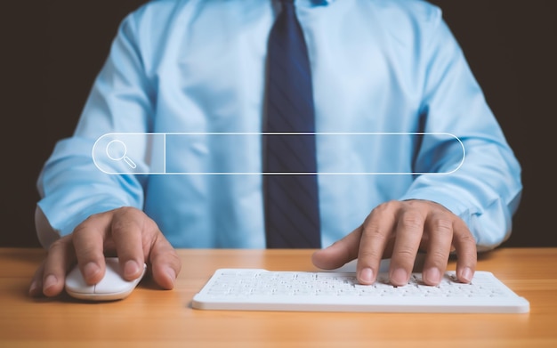 Human hand working on computer and search icon