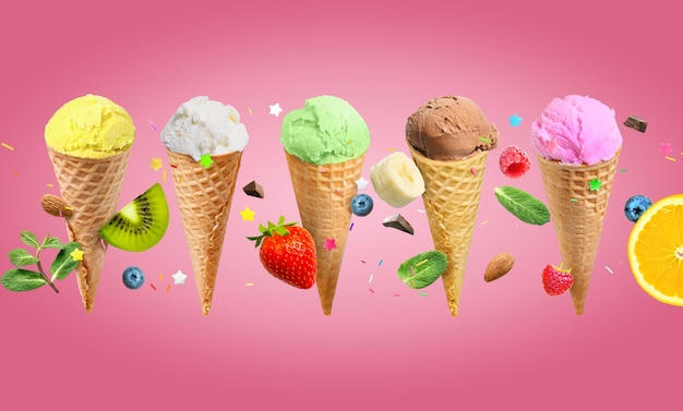 Ice cream scoops in waffle cones with fruits and berries on pink background