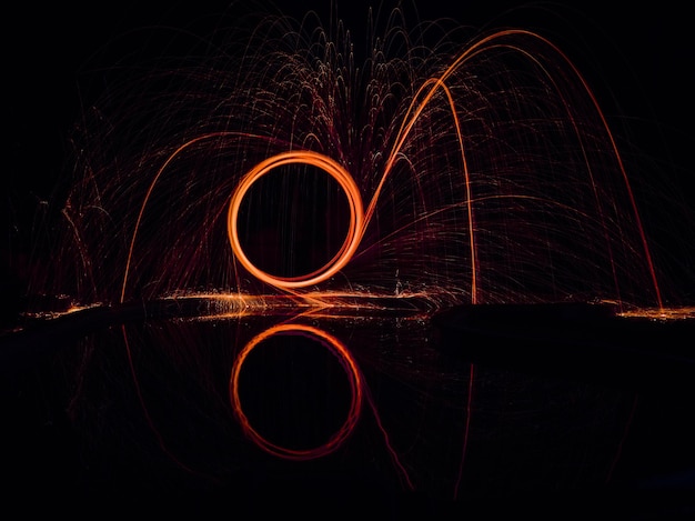 Illuminated wire wool at lakeshore