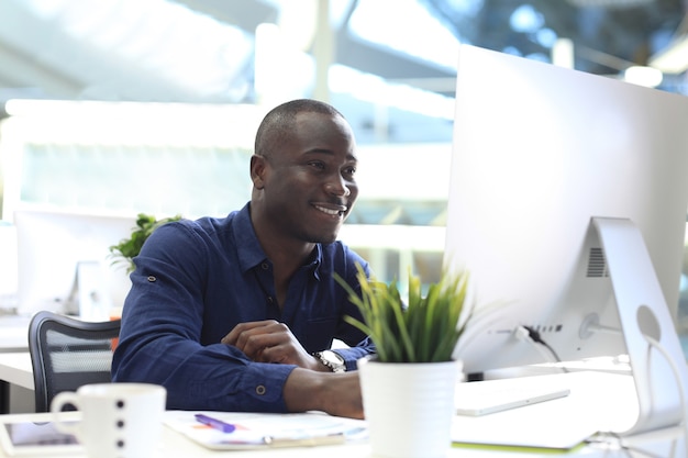 Image of african american businessman working on computer.