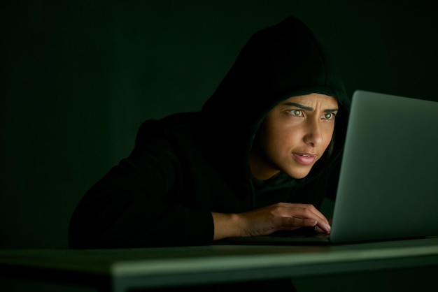 Indian woman hacker and mockup of banking and database web fraud with crypto data Programmer criminal and finance software hack with a hacking expert writing algorithm for cybercrime virus