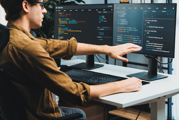 IT developer working online software development coding on pc screens Gusher