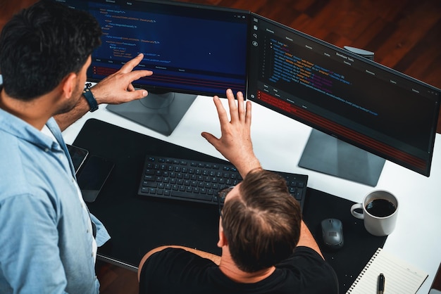 IT developers discussing online software development information on pc screen creating program coding for latest version application on website Concept of brainstorming firmware updated Sellable