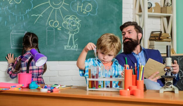 It is unbelievable children making science experiments Education Science and education chemistry lab happy children teacher back to school doing experiments with liquids in chemistry lab
