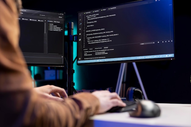 IT technician typing on keyboard installing safeguard code on PC