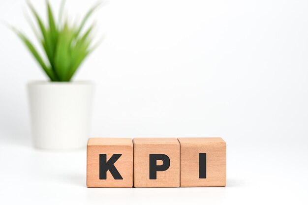 Key Performance Indicator concept text KPI written on wooden cubes on white background business p
