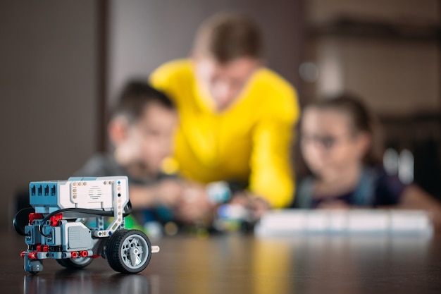 Kids creating robots with teacher.