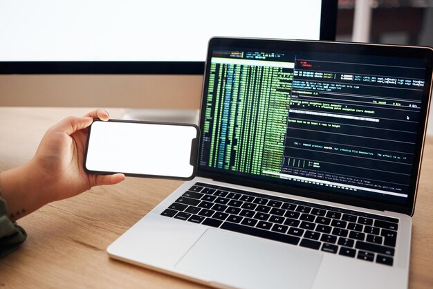 Laptop coding and hands with mockup phone for website hacking programming or cybersecurity Information technology software and person on smartphone and computer for big data update or web design