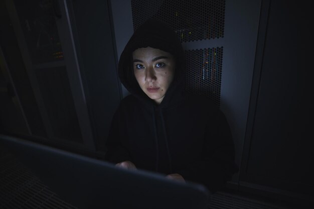 Laptop hacker and server with portrait of woman for coding software and cyber security Ransomware phishing and developer with girl programmer hacking for database network and digital crimes