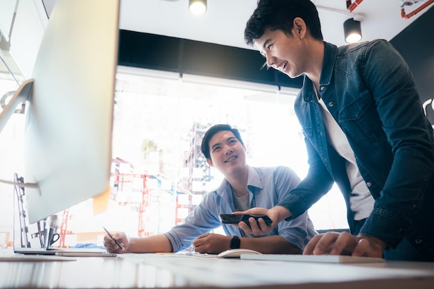 Low angle view of cheerful businessmen working in office