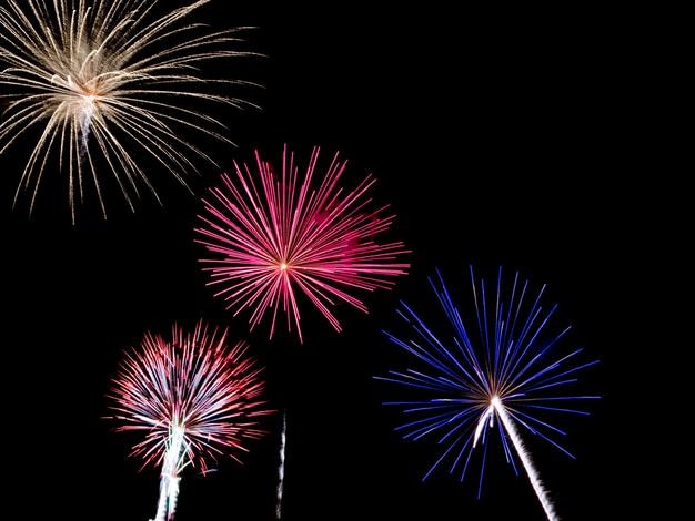 Low angle view of illuminated fireworks against sky at night