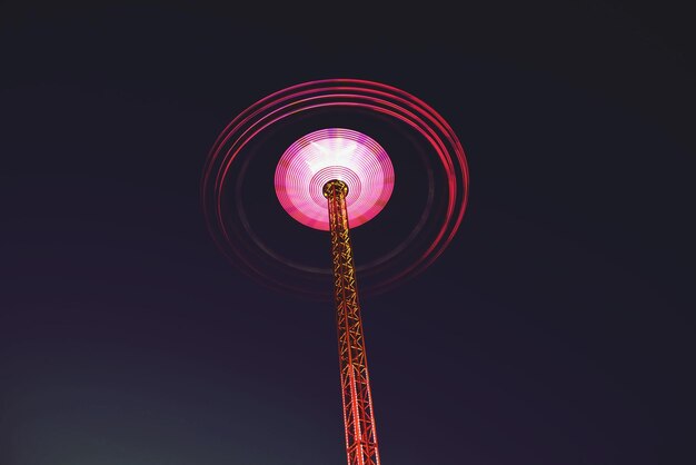 Low angle view of spinning amusement ride in motion