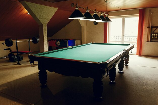 Luxury pool table at recreation room in rehabilitation centre in hospital billiard hobby equipment near weight lifting station relaxing sports game concept