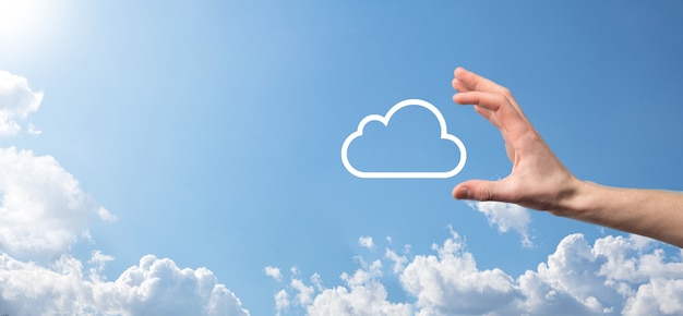 male hand holding house icon on blue background. property insurance and security concept.real estate concept.weather conditions, cloudiness.banner with copy space.