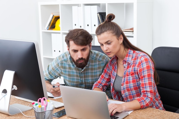 Man and woman looking at laptop screen