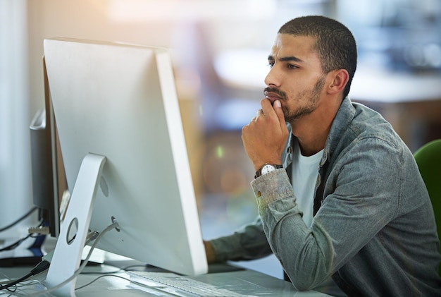 Man computer and thinking as web designer in office for software programming thoughts or project planning Male person desktop and IT decision with media research for networking skill or ideas