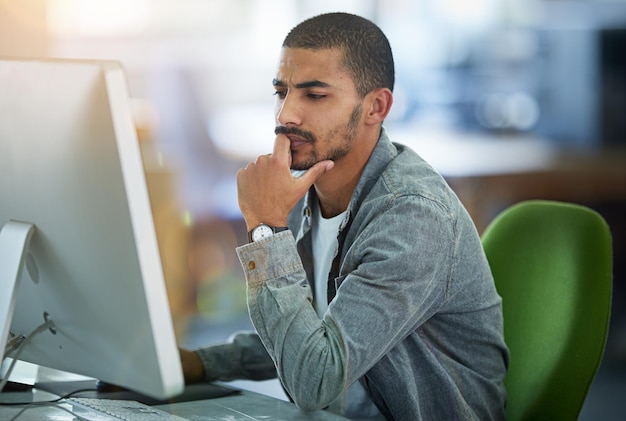 Man computer and thinking for web design or research for software programming thoughts or project planning Male person desktop and decision as media creative for networking ideas or solution