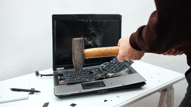 man destroyed laptop with a hammer Nervous work buggy computer errors slow Internet not saved in the game printed text hung Bad old computer failed does not turn on hangs close up