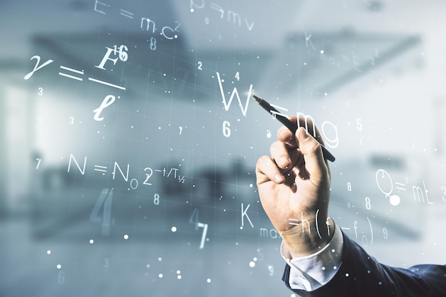 Man hand with pen working with scientific formula hologram on blurred classroom background research concept Multiexposure