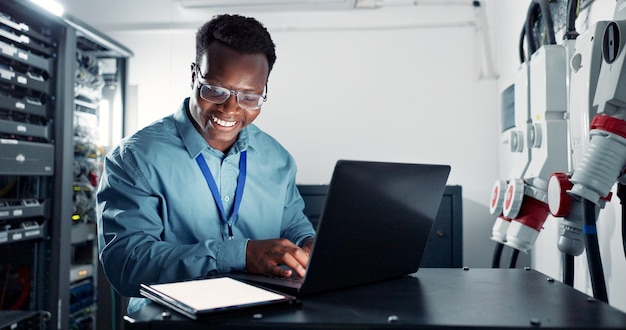 Man laptop and engineer coding in server room firmwear update and programmer for cyber security Developer confident and IT support or upgrade network with tablet database and data centre or tech