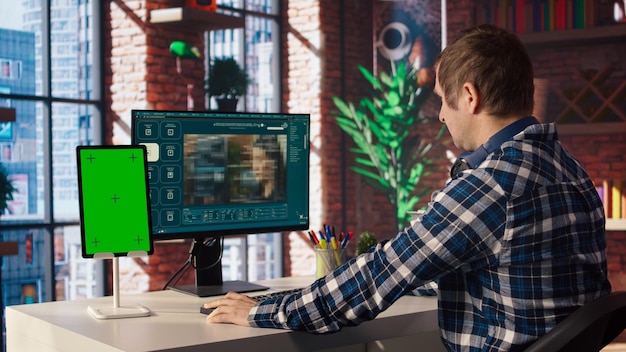 man looks at tutorial on chroma key tablet about ai virtual assistant