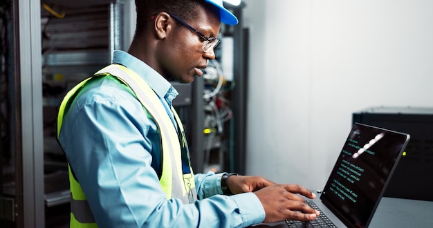 Man maintenance and server room or coding with laptop electrician and firmware update installation or system programming Network database and IT technician typing bigdata and software technology