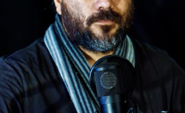 Man recording a song in a professional studio, selective focus