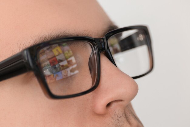 Man wearing glasses on light background closeup