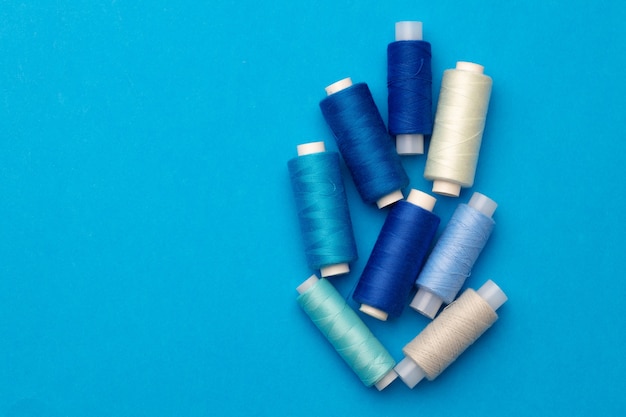 Many colored spools of threads as a background