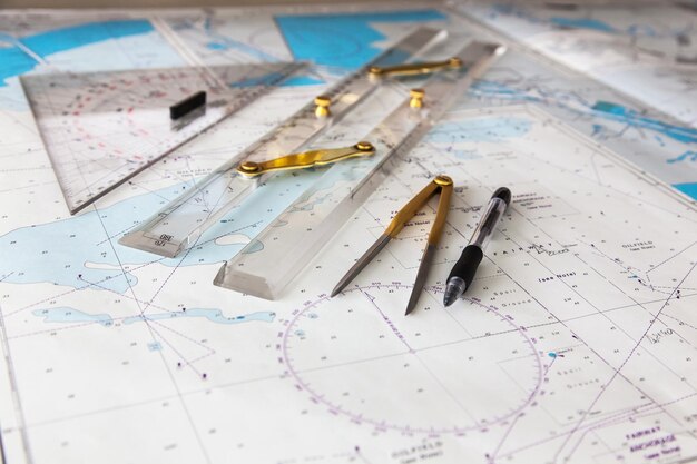 Maps of the ship for plotting Plotter divider ruler and pen Closeup