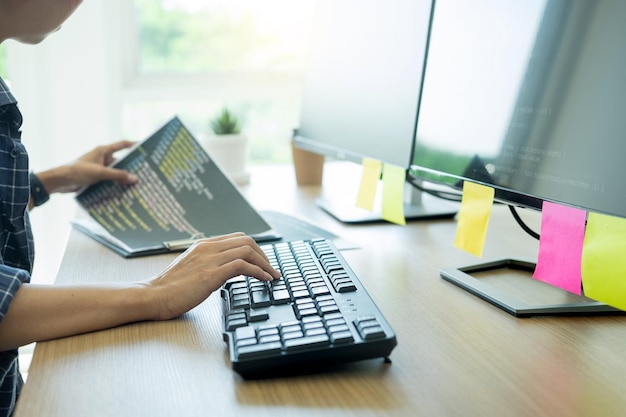 Midsection of businesswoman using computer on desk in office