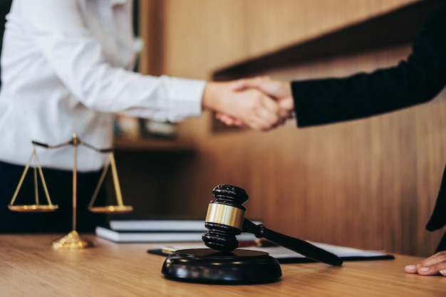 Midsection of people handshaking over table