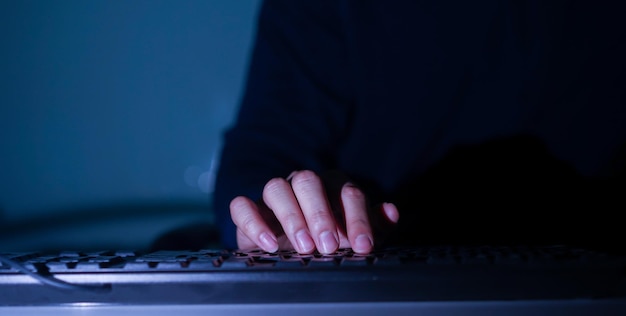 Midsection of person using keyboard on table