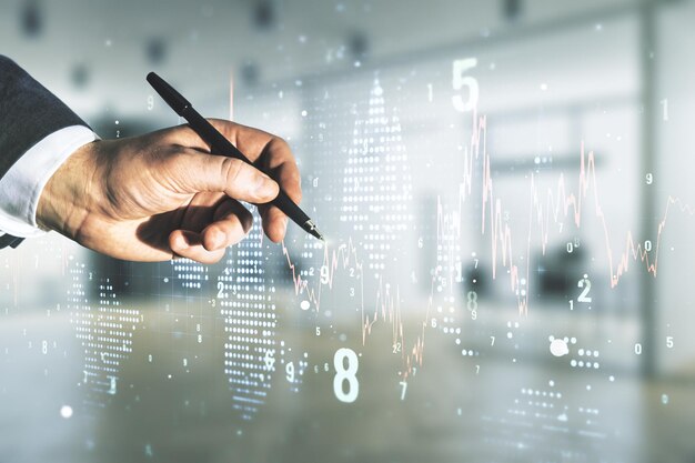 Miehen käsi kynällä työskentelee abstraktin virtuaalisen rahoituskaavion kanssa hämärtyneellä toimistotaustalla, forex- ja sijoituskonsepti. Monivalotus