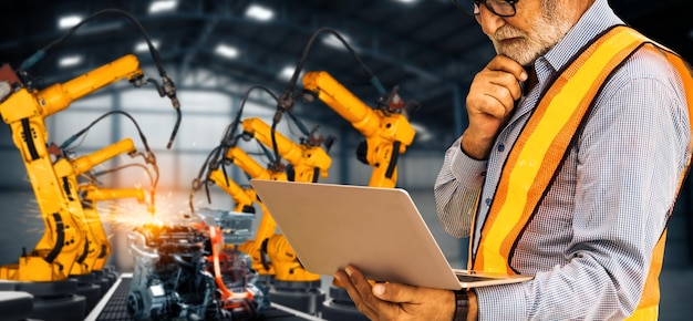 Mlp engineer use advanced robotic software to control industry robot arm in factory