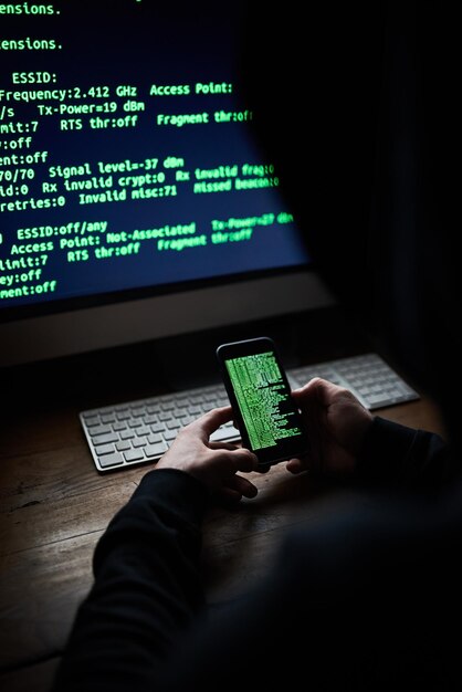 Mobile programmer hands and code screen with software for hacking crime or cyber security download or virus Hacker programming and thief with digital database for online glitch with web banking