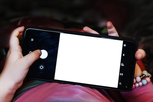 Mockupbanner white mockup on the phonebaby girl make selfie on mobile phone and lying in bed