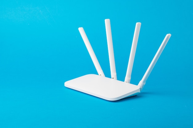 Modern stylish Wi-Fi router on a light blue surface. Organization of wireless networks.
